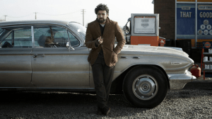 Inside Llewyn Davis- Oscar Isaac leaning on car
