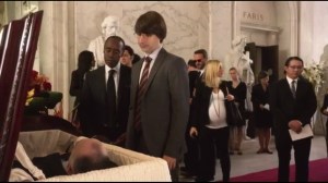 At the End of the Day, Reality Wins- At funeral, introduction to Ellis Gage Hightower, played by Demitri Martin