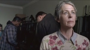 Forget- Carol surveys the armory while others check out guns