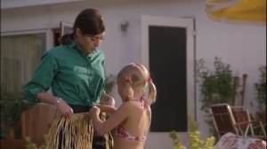 Parliament of Owls- Jenny puts a grass skirt on Virginia as they prepare to hula