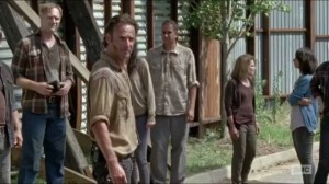 Now- Rick tells the townspeople that the walls will hold together to keep out the walkers