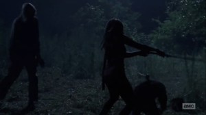 The Obliged- Michonne hacks down walkers at night- The Walking Dead, AMC