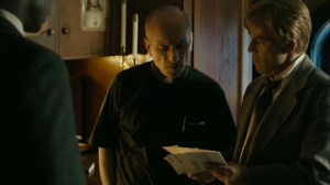 The Hour and the Day- Roland shows the pastor some photos of the straw dolls- HBO, True Detective