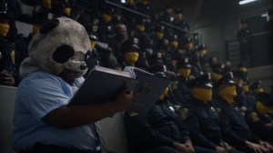 It's Summer and We're Running Out of Ice- Panda, played by Jacob Ming-Trent, reads about the authorized release of weapons- HBO, Watchmen