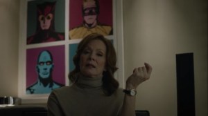 She Was Killed By Space Junk- Laurie with a poster behind her of Manhattan, Silk Spectre, Ozymandias, and Nite Owl- HBO, Watchmen