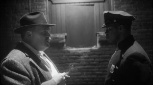 This Extraordinary Being- Will questions Fred, played by Glenn Fleshler, on the burning of a Jewish bakery- HBO, Watchmen